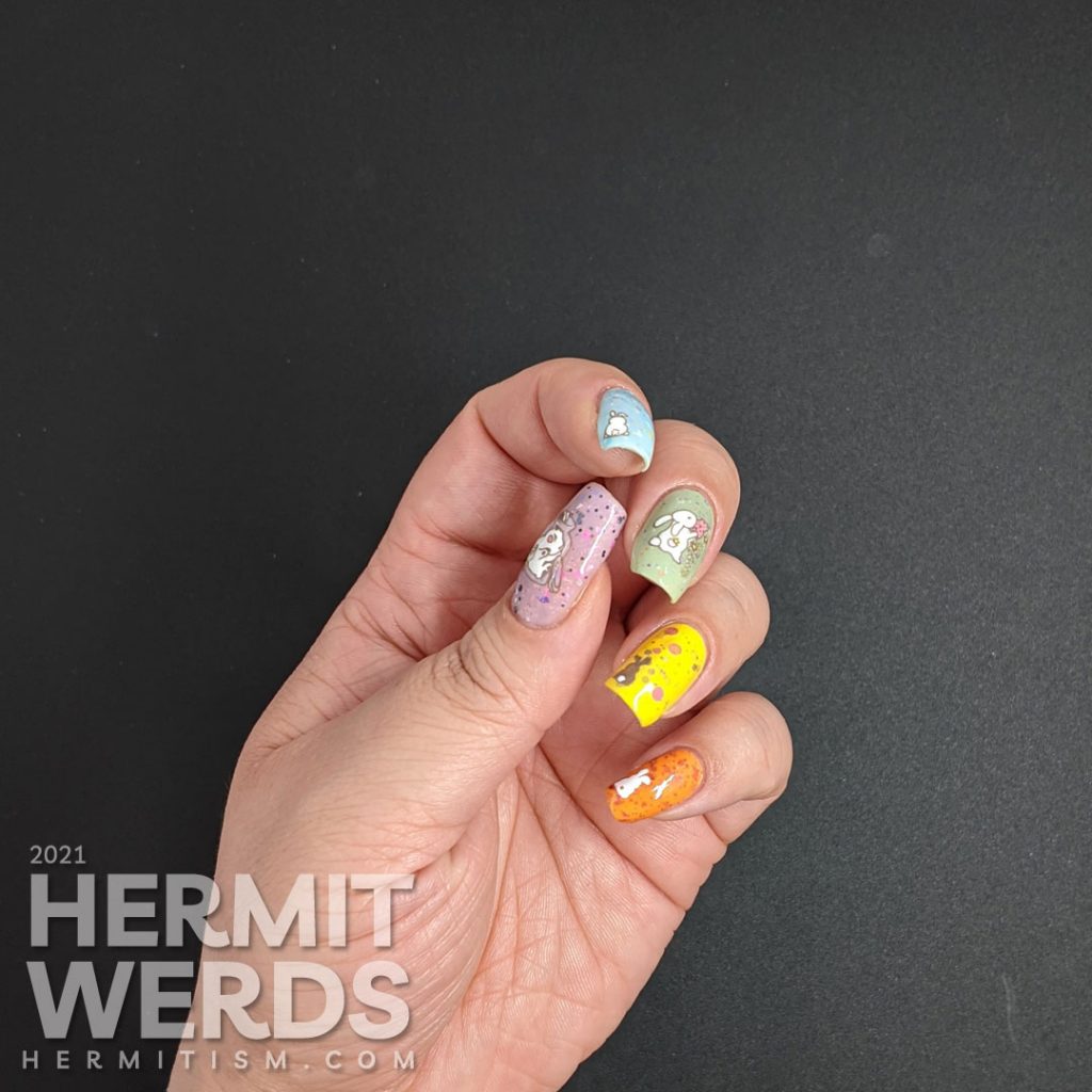 A pastel Easter crelly skittle nail design with a magical bunny, cute bunny butts, and a bunny in a jar for next year.