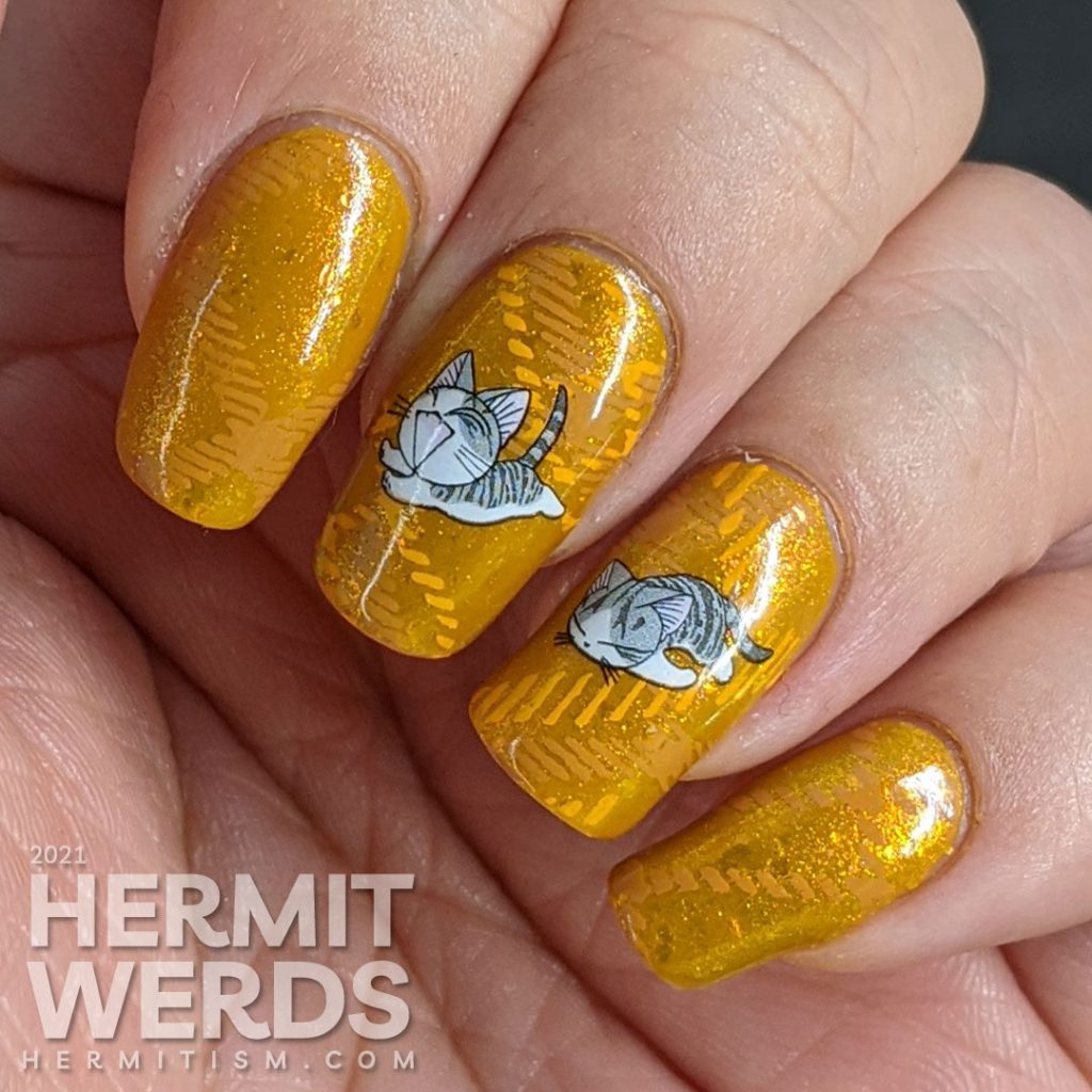 A super mustard-y nail art with a stamped plaid background pattern and cute grey cat water decals sleeping, playing, and talking to you.