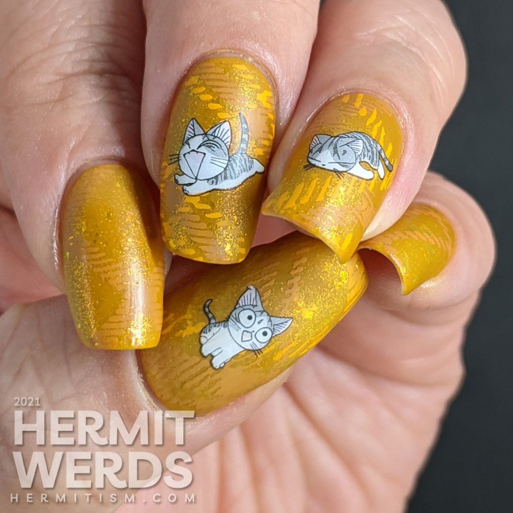 A super mustard-y nail art with a stamped plaid background pattern and cute grey cat water decals sleeping, playing, and talking to you.