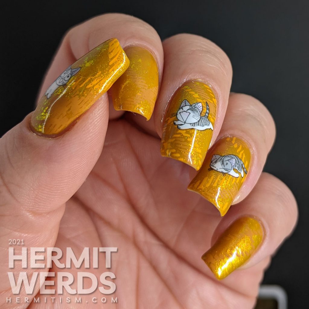 A super mustard-y nail art with a stamped plaid background pattern and cute grey cat water decals sleeping, playing, and talking to you.