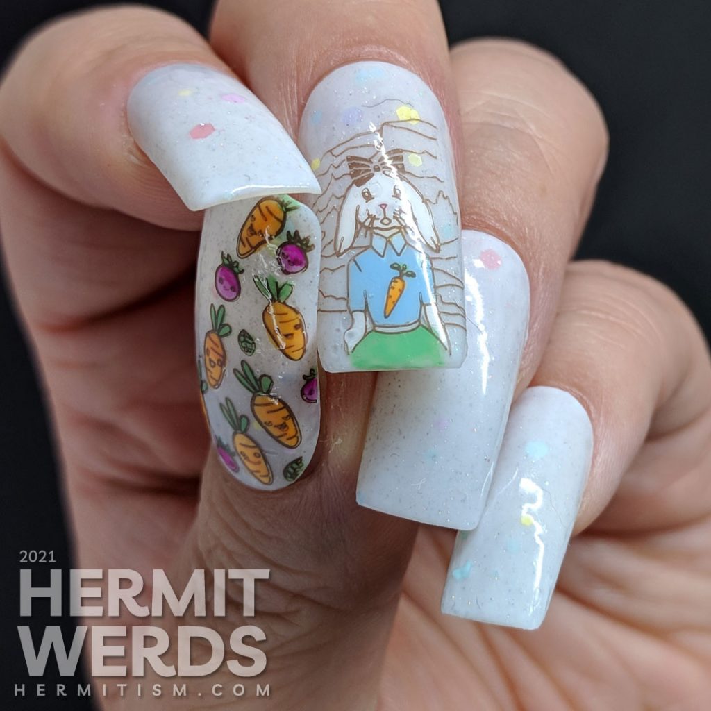 Easter nail art starting with a soft grey crelly with pastel glitters and a cute anthropomorphic bunny wearing a carrot t-shirt and carrots!