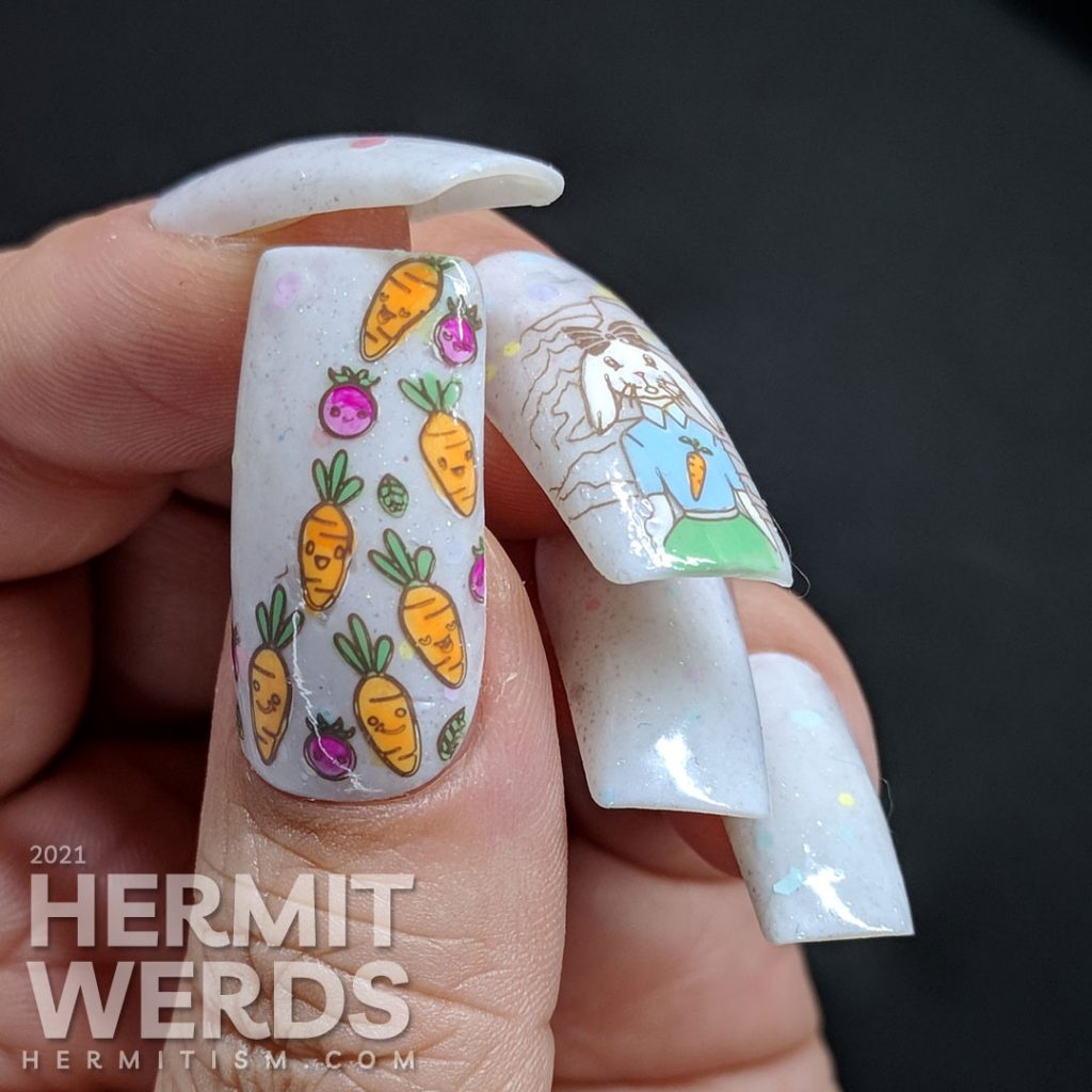 Easter nail art starting with a soft grey crelly with pastel glitters and a cute anthropomorphic bunny wearing a carrot t-shirt and carrots!