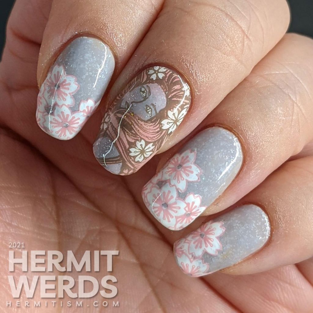 A soft grey nail art with stamping decals of sakura blossom French tips a pink-haired woman with more flowers and a blooming cherry tree.