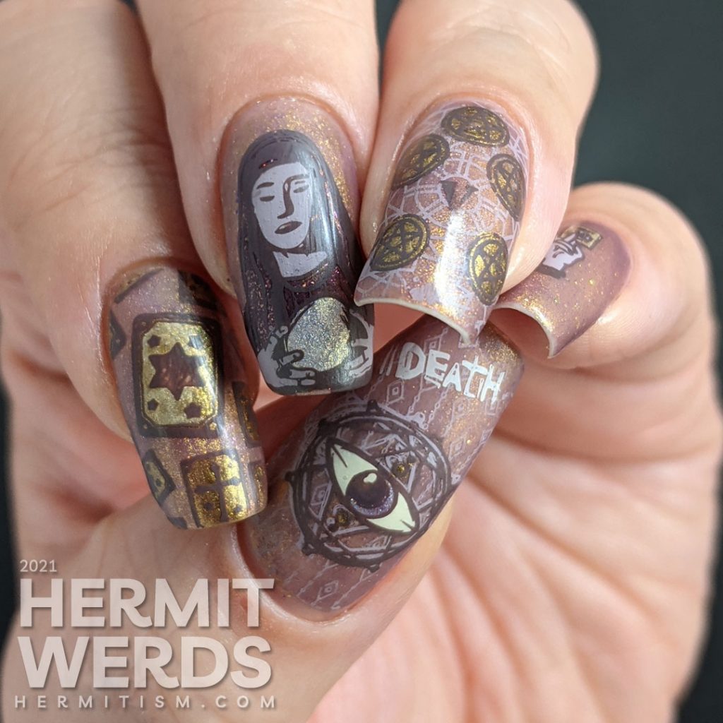 A mauve and gold magnetic nail art with tarot cards, the five of pentacles, all-seeing eye, and a fortune teller and her crystal ball.