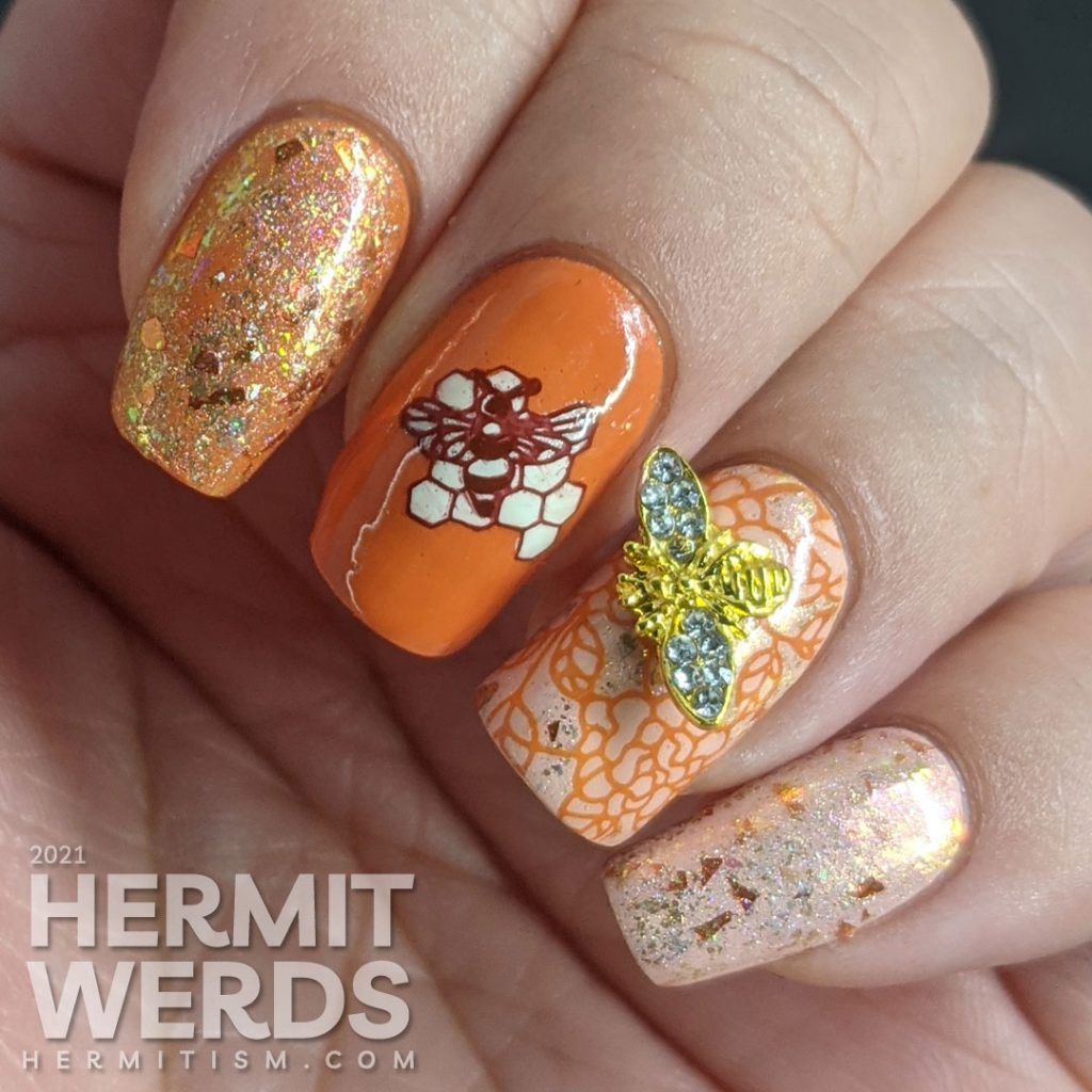 An orange and light pink mani with a super flakie rose gold topper, gold bee nail charm, and simple bee mosaic stamping decals.
