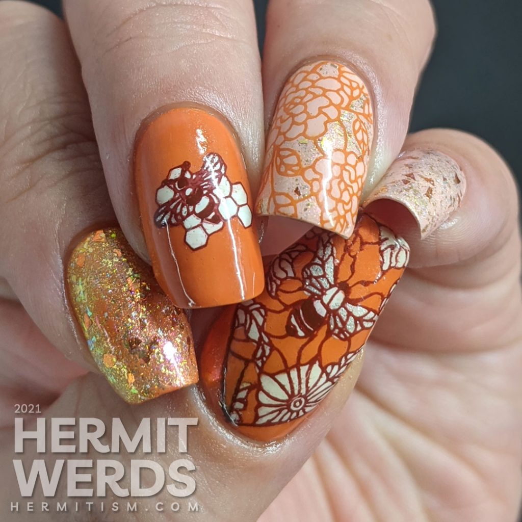 An orange and light pink mani with a super flakie rose gold topper, gold bee nail charm, and simple bee mosaic stamping decals.