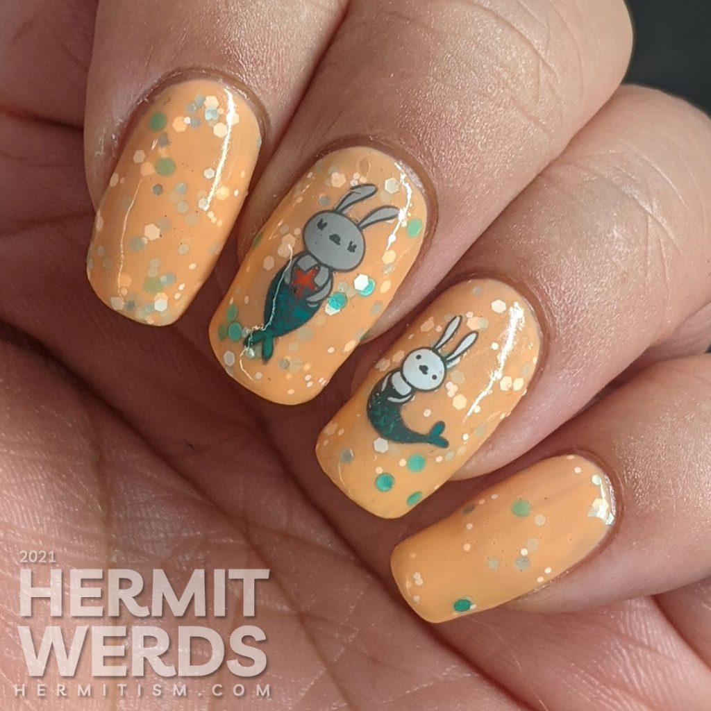 A bright pastel orange crelly with bunny mermaids (or bunnymaid) stamping decals with starfish and teal and white accents.