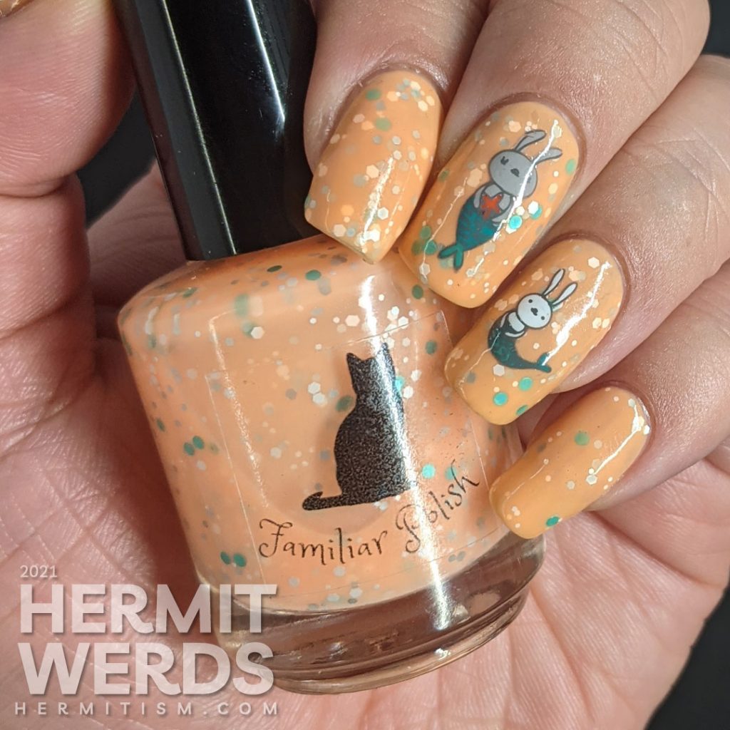 A bright pastel orange crelly with bunny mermaids (or bunnymaid) stamping decals with starfish and teal and white accents.