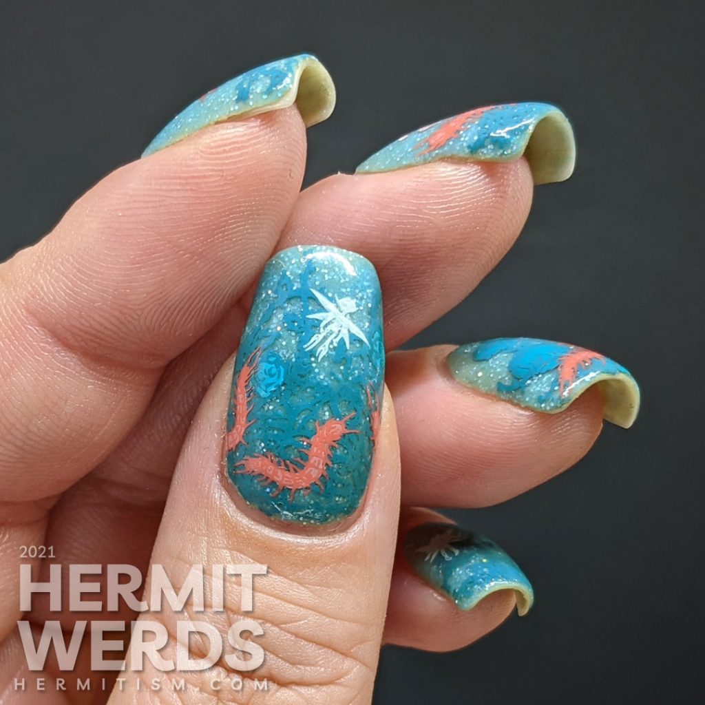 Thorny teal rose vines against a glow in the dark sparkly teal base with fairy and centipede reverse stamping decals.