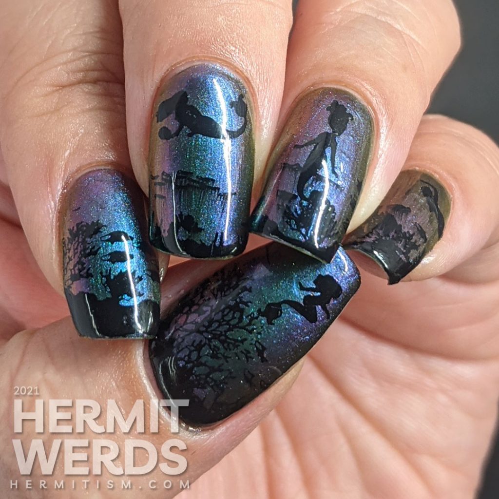 An ultra multichrome base polish from turquoise to purple to orange with ocean floor and swimming mermaids stamped on in black.