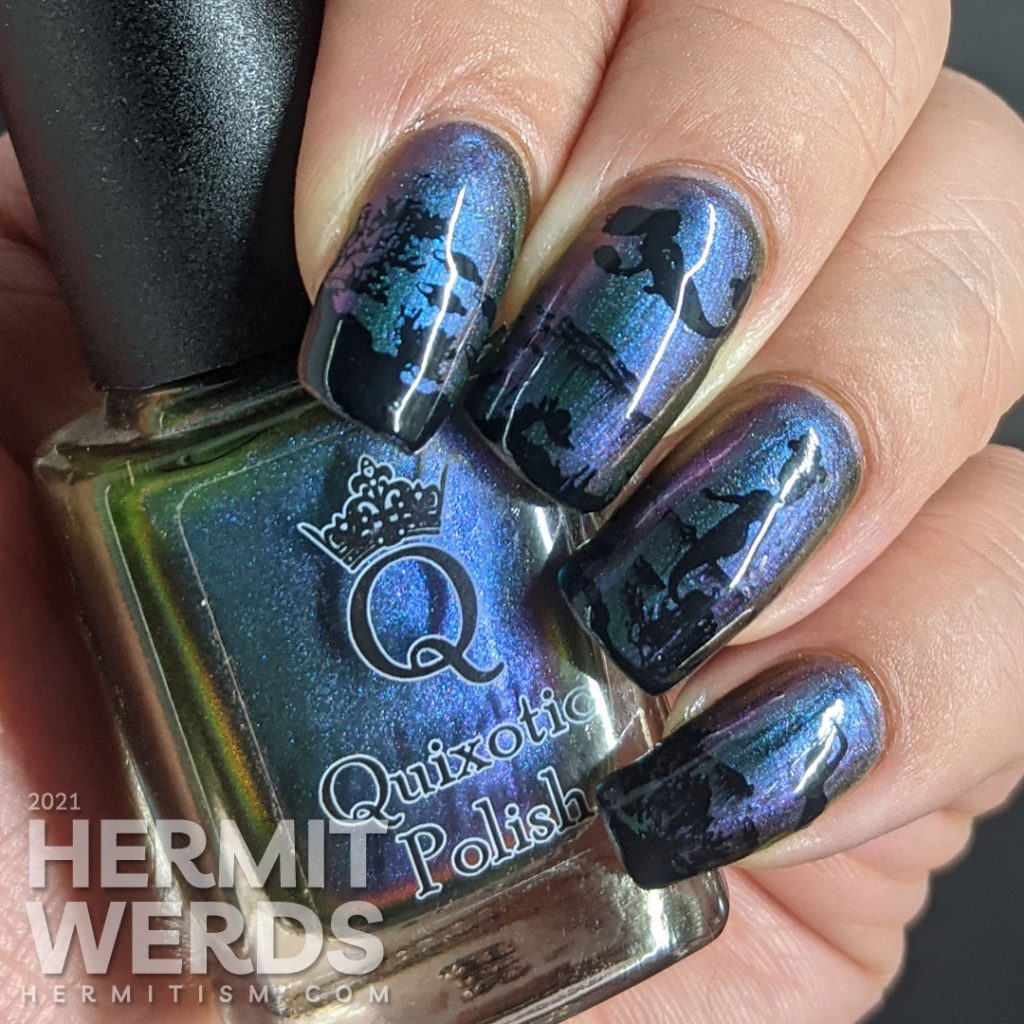 An ultra multichrome base polish from turquoise to purple to orange with ocean floor and swimming mermaids stamped on in black.