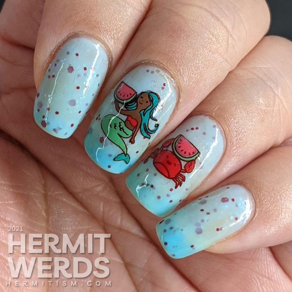 A turquoise to white thermal nail polish with stamping decals of a mermaid and crab enjoying watermelon and a full-nail watermelon pattern on the thumb.