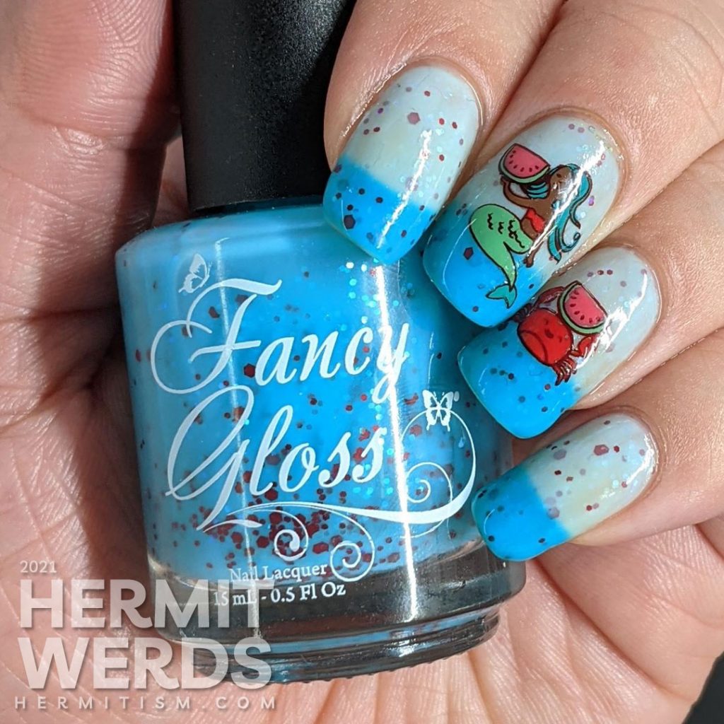 A turquoise to white thermal nail polish with stamping decals of a mermaid and crab enjoying watermelon and a full-nail watermelon pattern on the thumb.