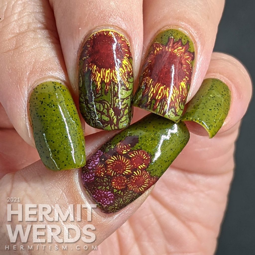 Autumn-esque nail art of yellow, orange, and brown sunflower stamping decals on an olive green speckled nail polish base.