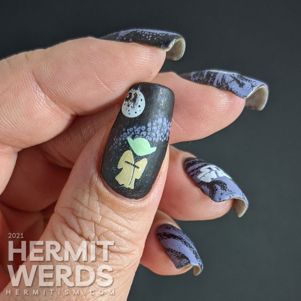 A black and purple Star Wars nail art with the Mandalorian's helm and Yoda silhouetted against a field of stars.