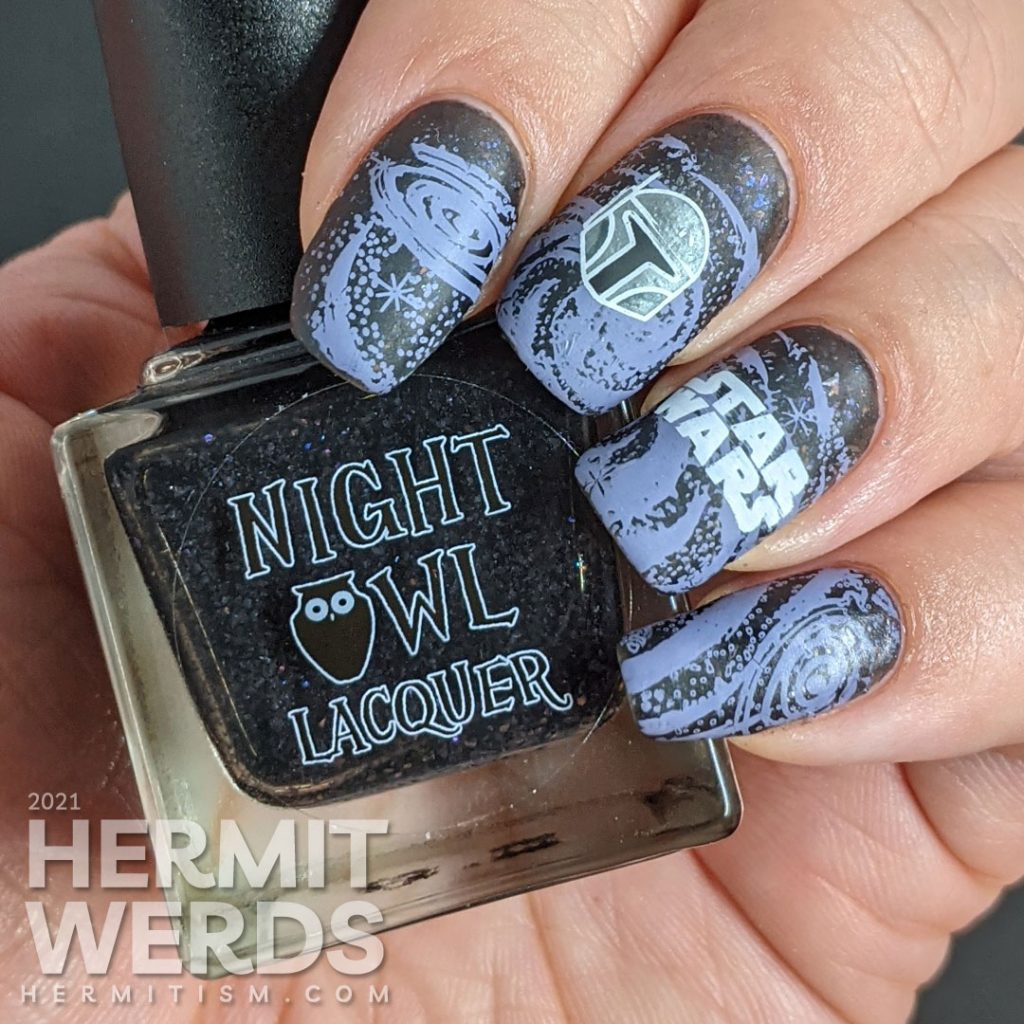 A black and purple Star Wars nail art with the Mandalorian's helm and Yoda silhouetted against a field of stars.