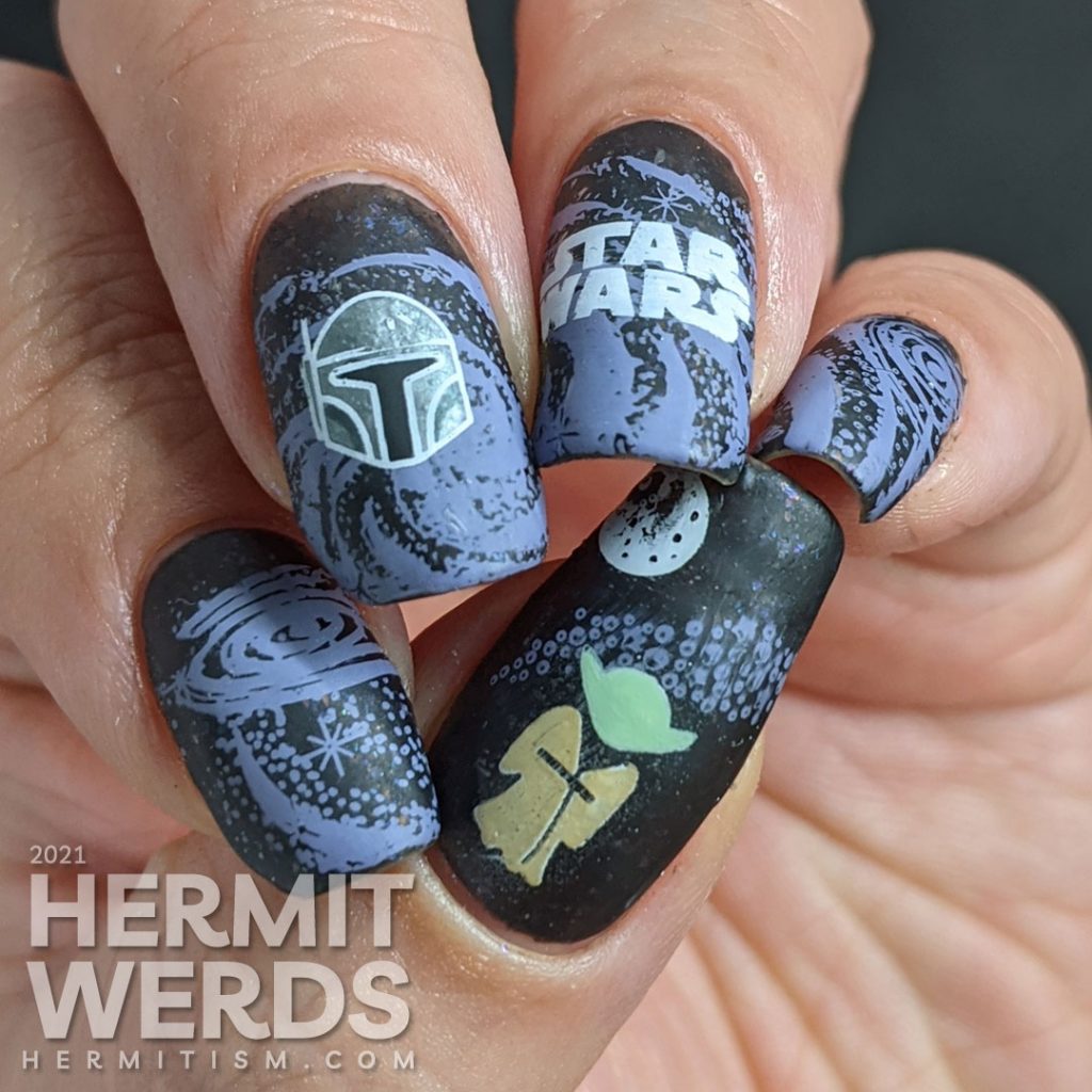 A black and purple Star Wars nail art with the Mandalorian's helm and Yoda silhouetted against a field of stars.