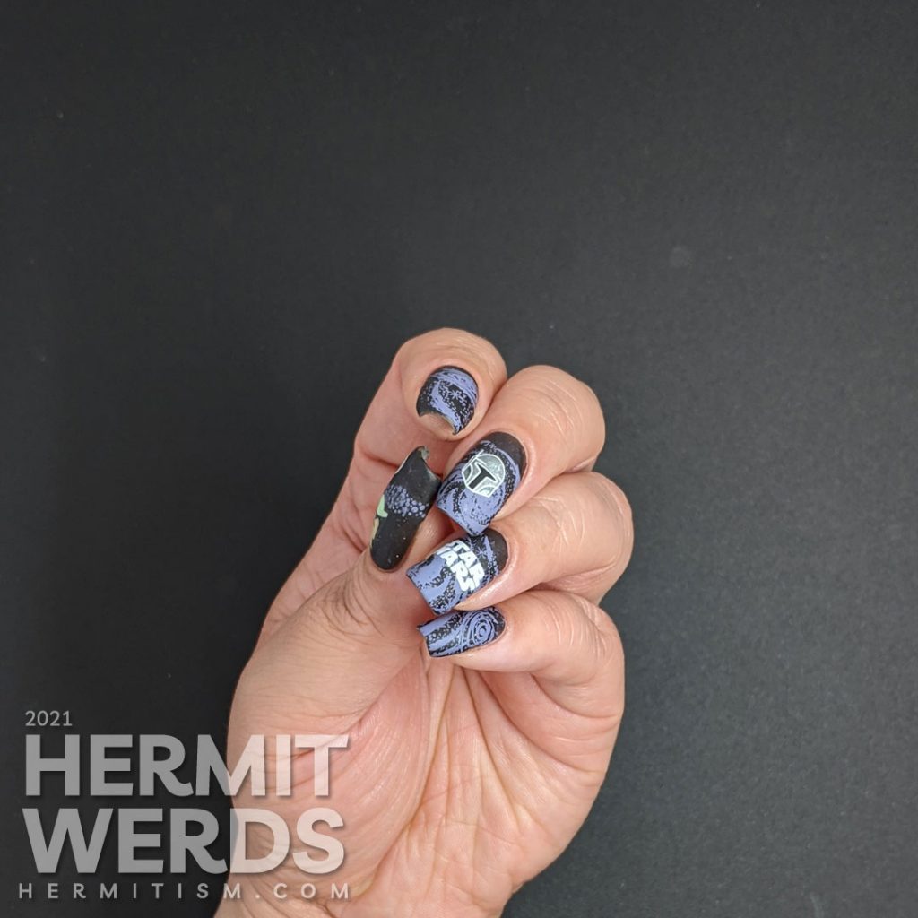 A black and purple Star Wars nail art with the Mandalorian's helm and Yoda silhouetted against a field of stars.