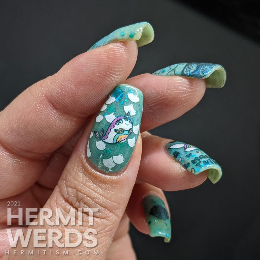 Teal glow in the dark nail art with a mermaid unicorn (mermicorn) stamping decal and a narwhale.