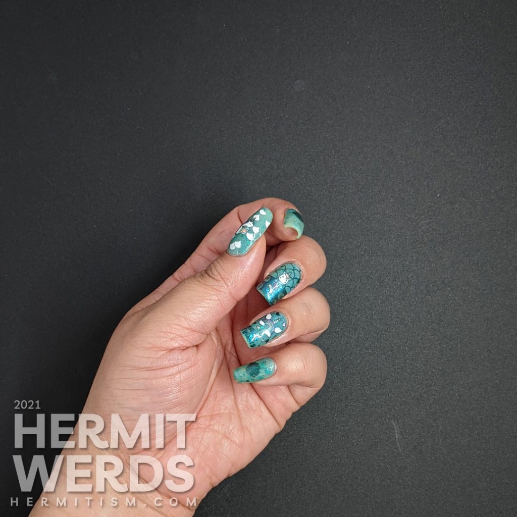 Teal glow in the dark nail art with a mermaid unicorn (mermicorn) stamping decal and a narwhale.