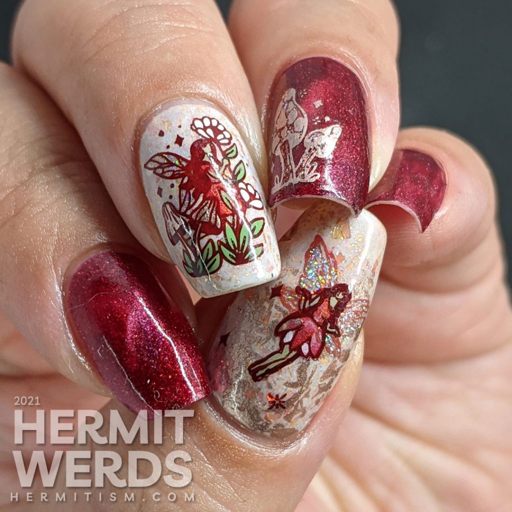 A red magnetic nail art with soft rose gold crelly accent nails and stamping decals of fairies, mushrooms, and flora.