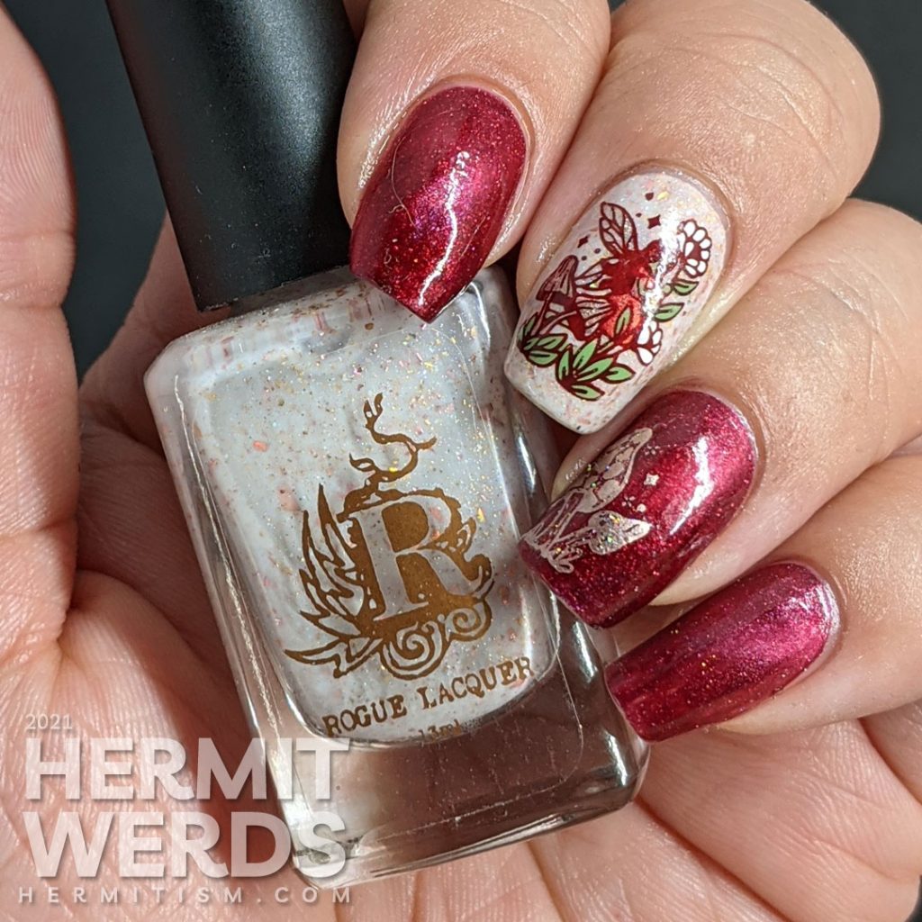 A red magnetic nail art with soft rose gold crelly accent nails and stamping decals of fairies, mushrooms, and flora.