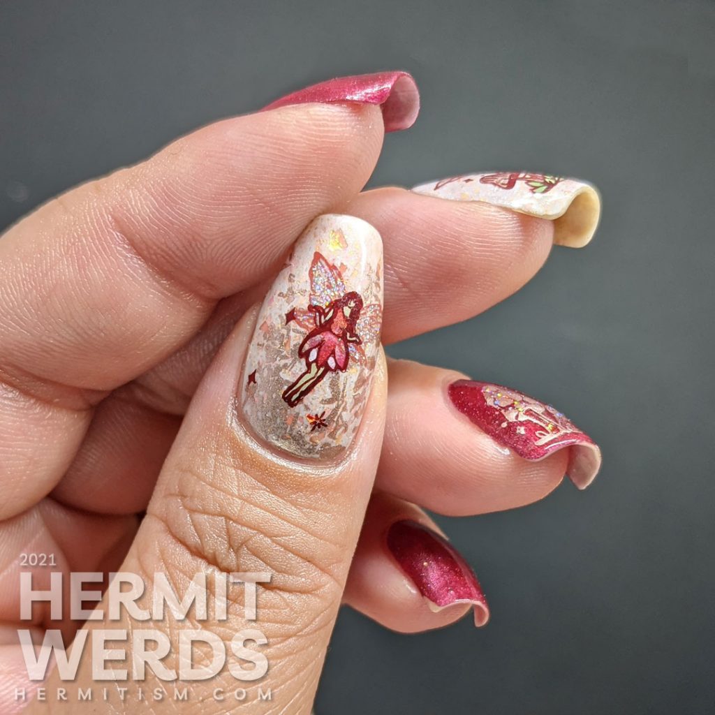 A red magnetic nail art with soft rose gold crelly accent nails and stamping decals of fairies, mushrooms, and flora.