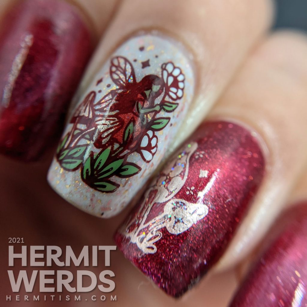 A red magnetic nail art with soft rose gold crelly accent nails and stamping decals of fairies, mushrooms, and flora.