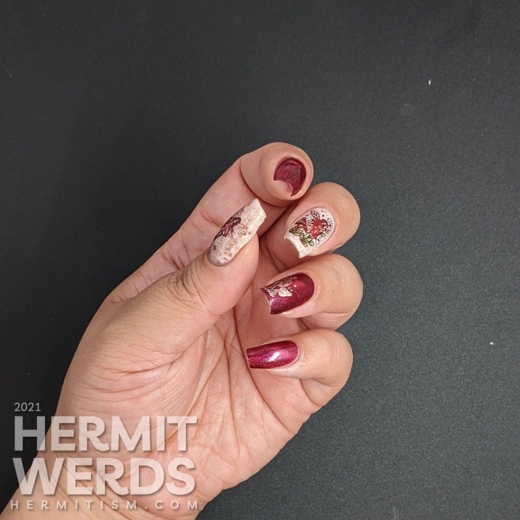 A red magnetic nail art with soft rose gold crelly accent nails and stamping decals of fairies, mushrooms, and flora.