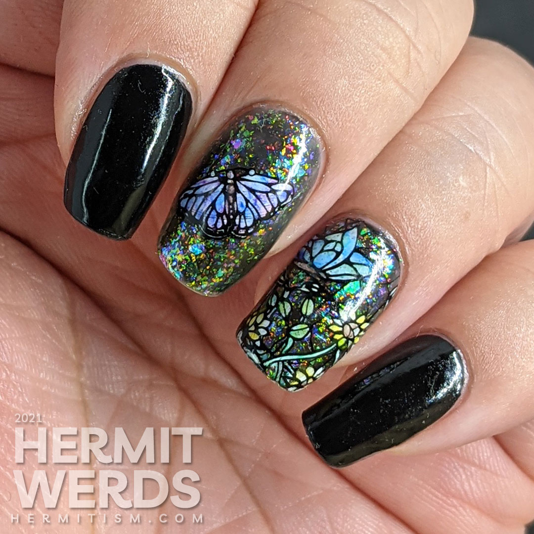 A stained glass butterfly nail art with an iridescent flakie topper and watercolor paint to fill in the butterfly decals.