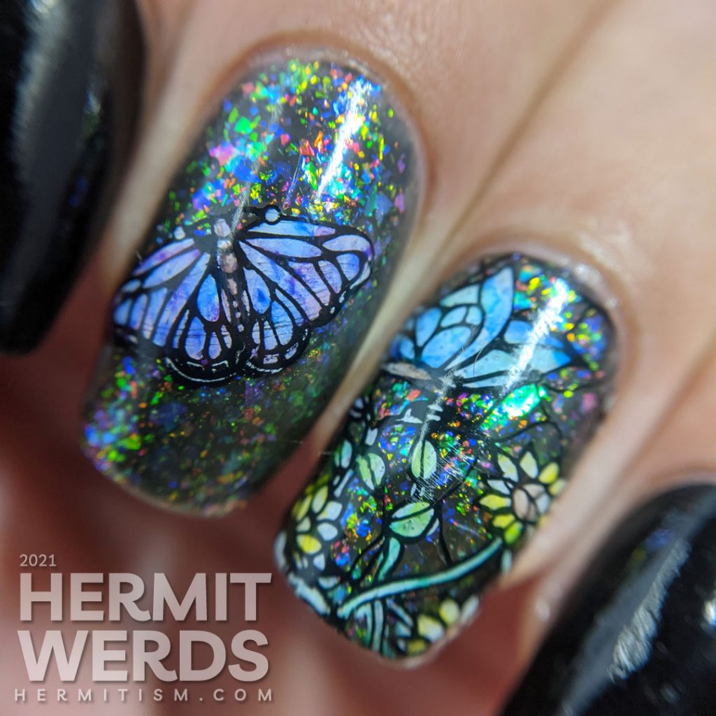 A stained glass butterfly nail art with an iridescent flakie topper and watercolor paint to fill in the butterfly decals.