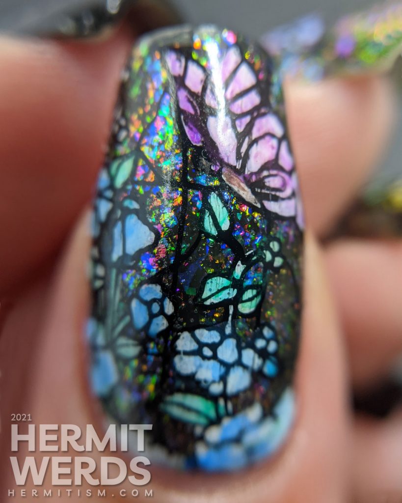 A stained glass butterfly nail art with an iridescent flakie topper and watercolor paint to fill in the butterfly decals.