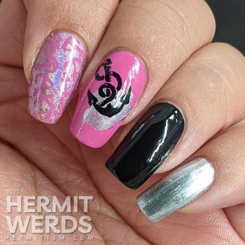 Nautical nail art in pink, black, and silver with lots of anchor stamping decals and a kiss of holographic nail polish.