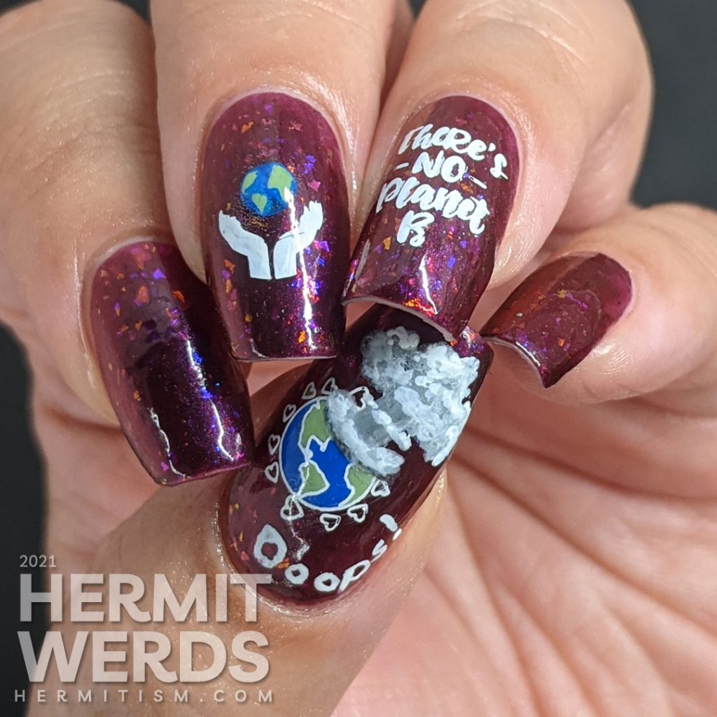 A plum flakie filled polish with earth-loving stamping images on top and a surprise nuclear explosion blowing up the planet. Oops!