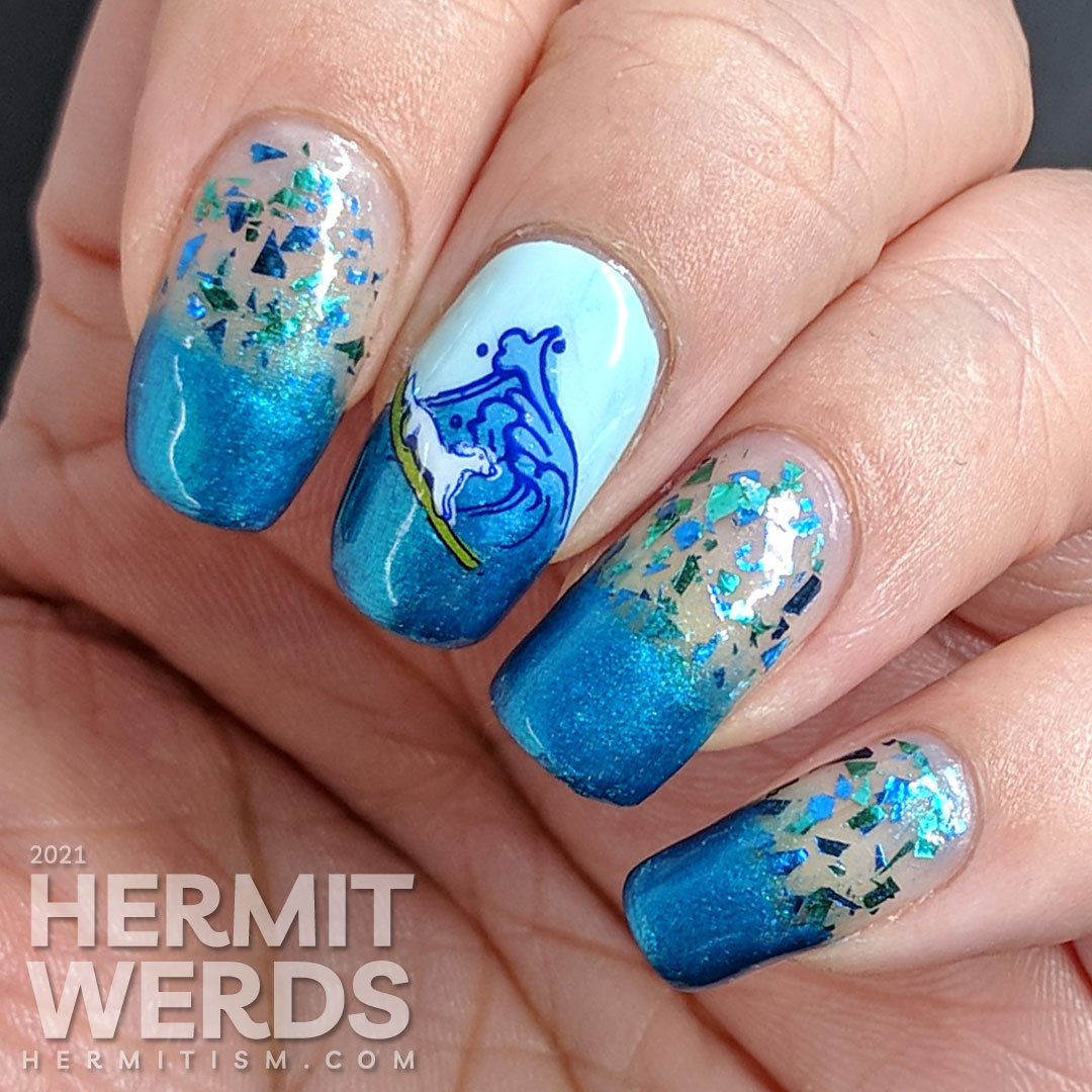 Shimmery blue and green ocean nail art with a stamping decal of a little white dog catching a wave/surfing.