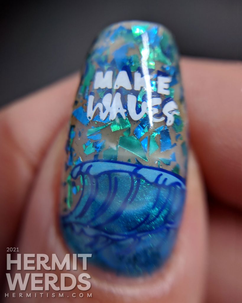 Shimmery blue and green ocean nail art with a stamping decal of a little white dog catching a wave/surfing.