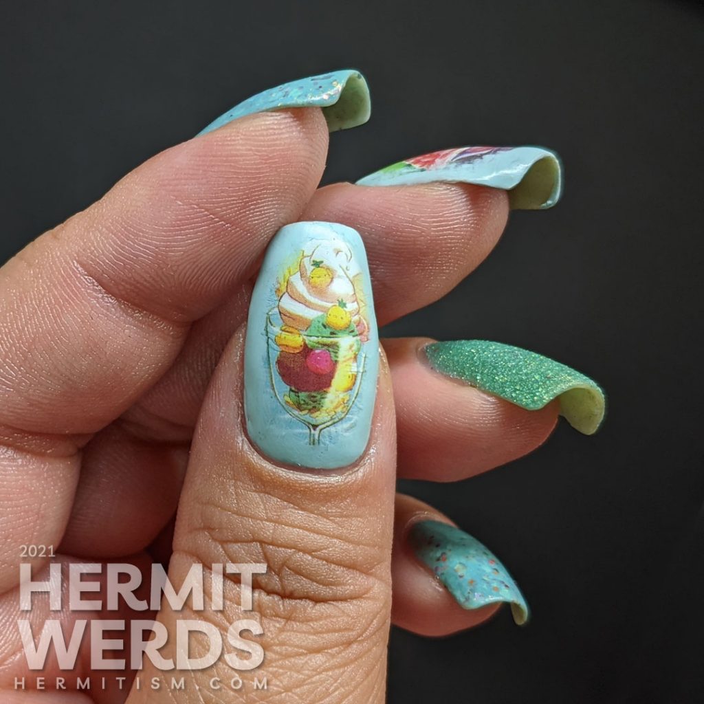 Teal/blue-green nail polishes with soft watercolor-like water decals of yummy ice cream dishes (sundae and milkshake) on top.