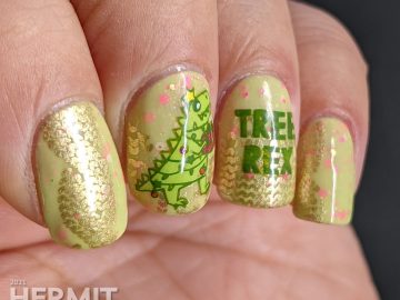 Christmas nail art with stamping decals of Tree Rex & dinosaurs in cozy sweaters in neon pink, green, yellow, and white on a green crelly.