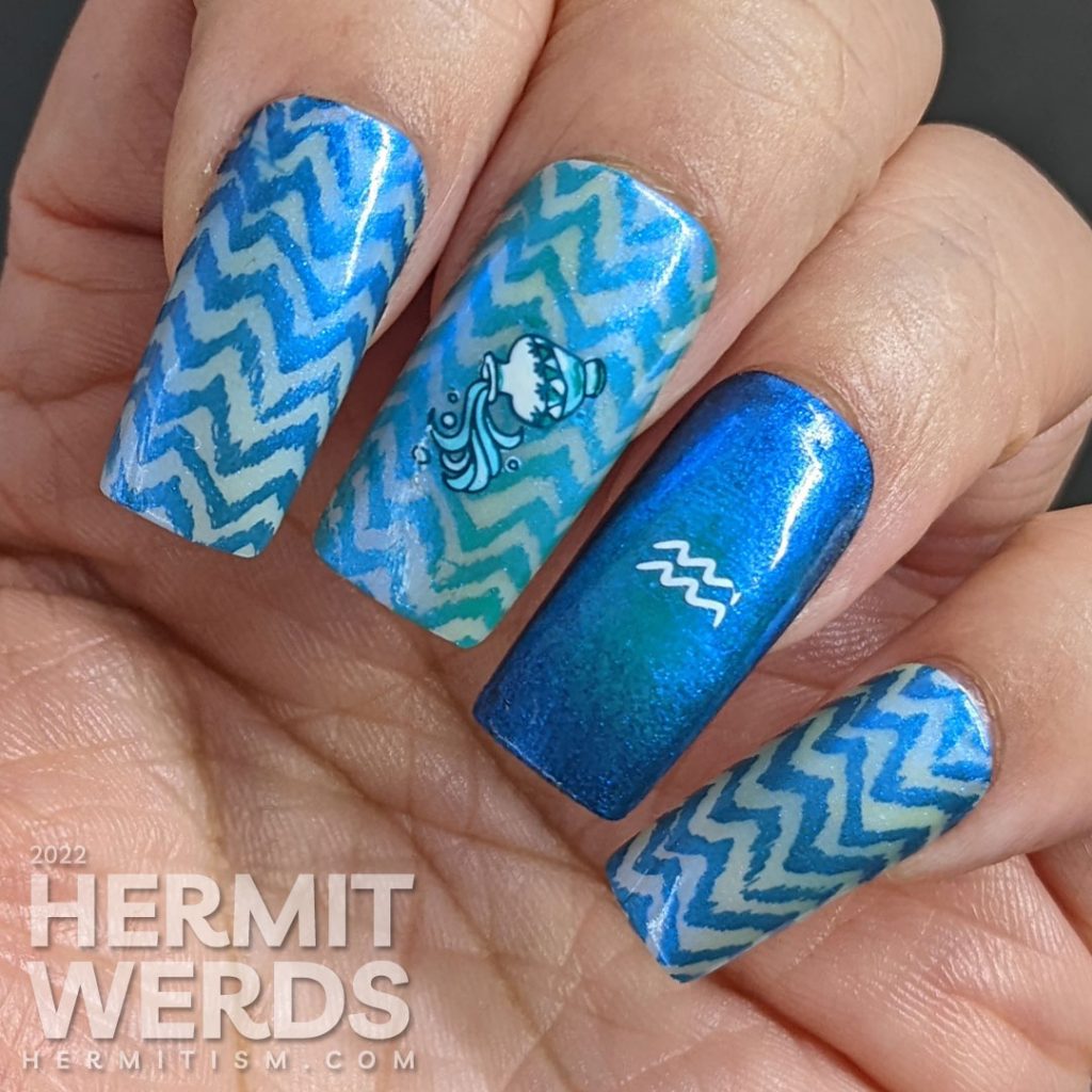 An aquarius/zodiac themed nail art with lots of blue chevrons and nail stamping images of Aquarius symbols.