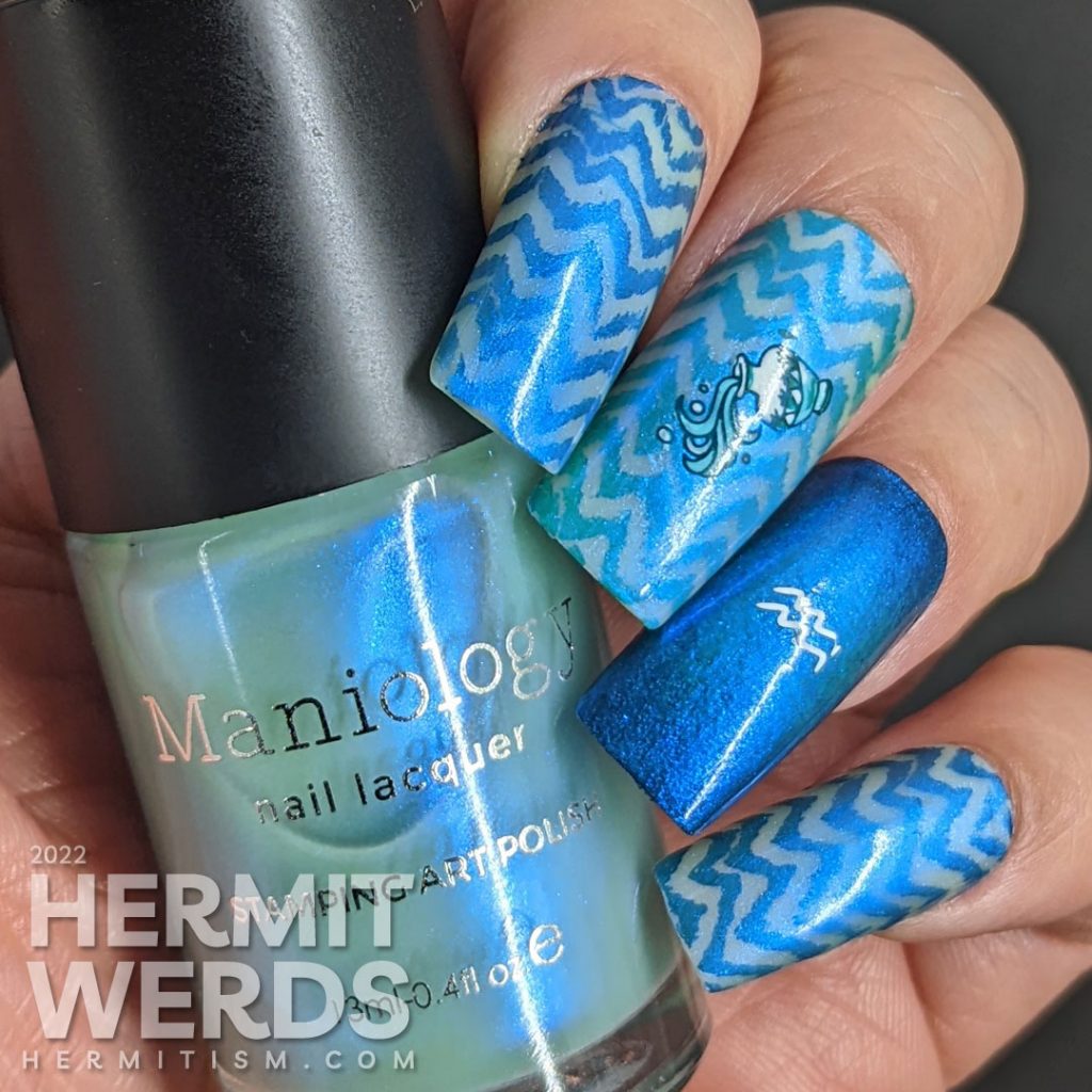 An aquarius/zodiac themed nail art with lots of blue chevrons and nail stamping images of Aquarius symbols.