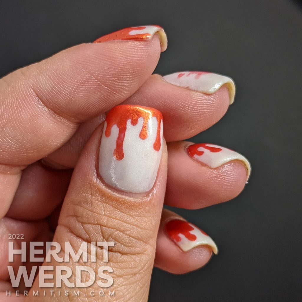 Orange and white bloody french tip drip nail art on a glow in the dark base with a bloody brain stamping decal.