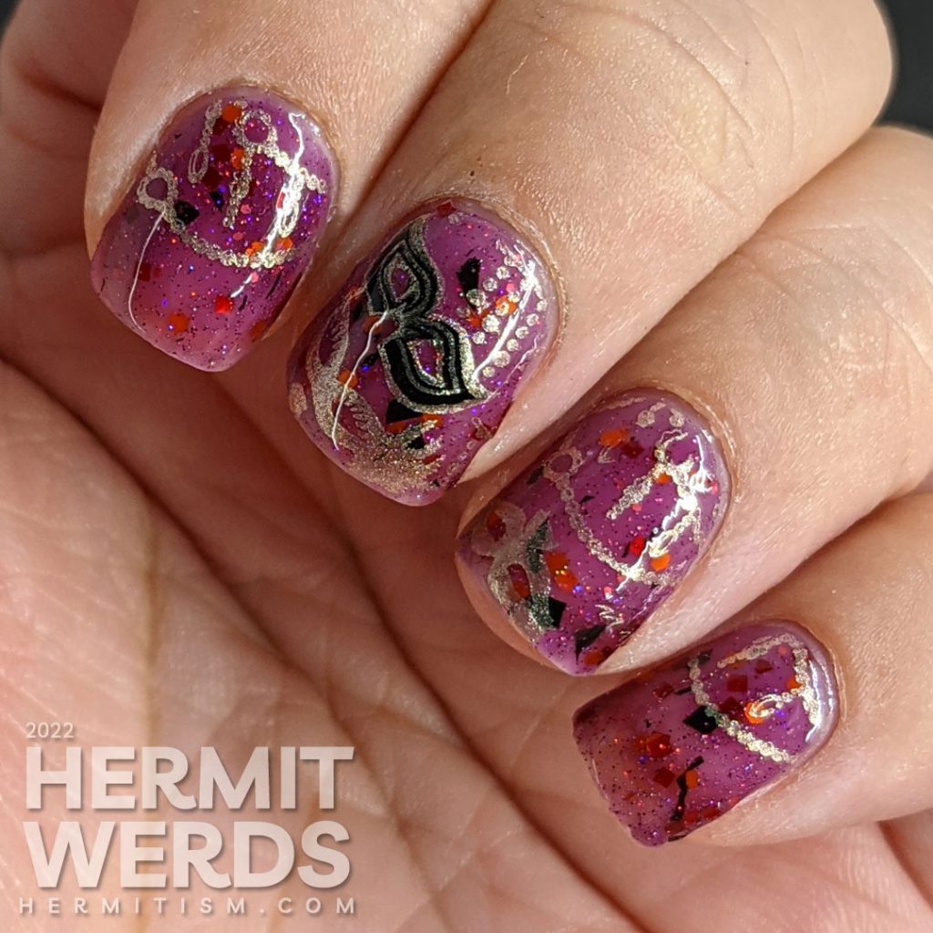 A plum-colored nail art celebrating Carnival season in Italy with golden strings of beads and many different masks.