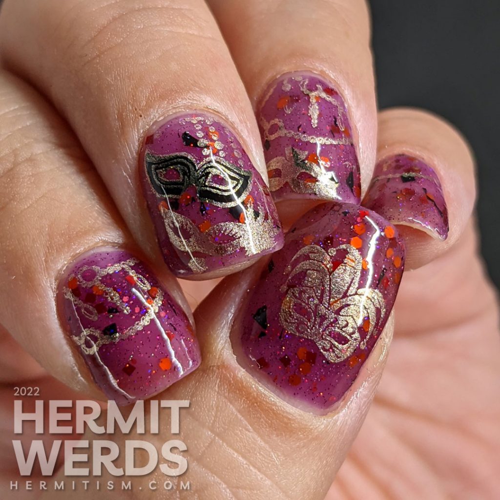 A plum-colored nail art celebrating Carnival season in Italy with golden strings of beads and many different masks.