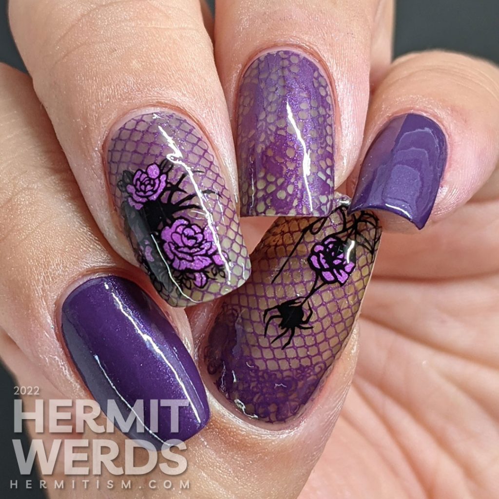 A gothic purple spider mani with lacy purple accent nails decorated with rose, spider, and lace stamping decals.