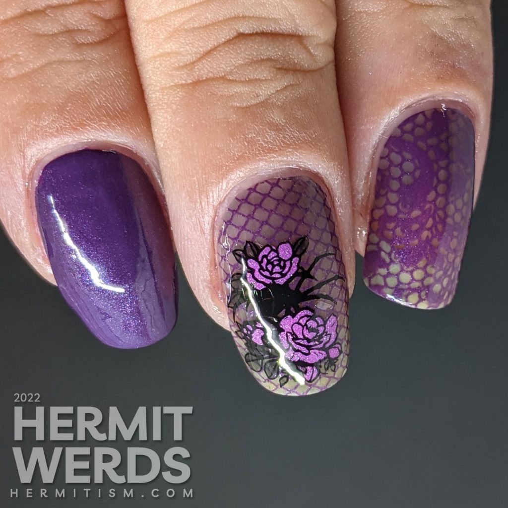 A gothic purple spider mani with lacy purple accent nails decorated with rose, spider, and lace stamping decals.