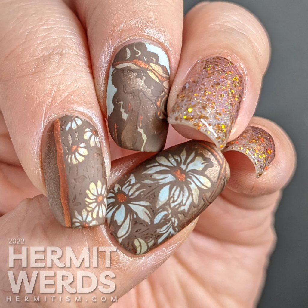 A soft, golden brown art nouveau nail art with a beautiful art nouveau woman, florals, and accompanying sparkly accent nails.