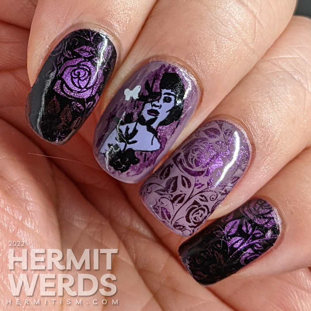 Dramatic purple rose nail art with a magnetic purple polish peeking out from negative space rose patterns and token butterflies.