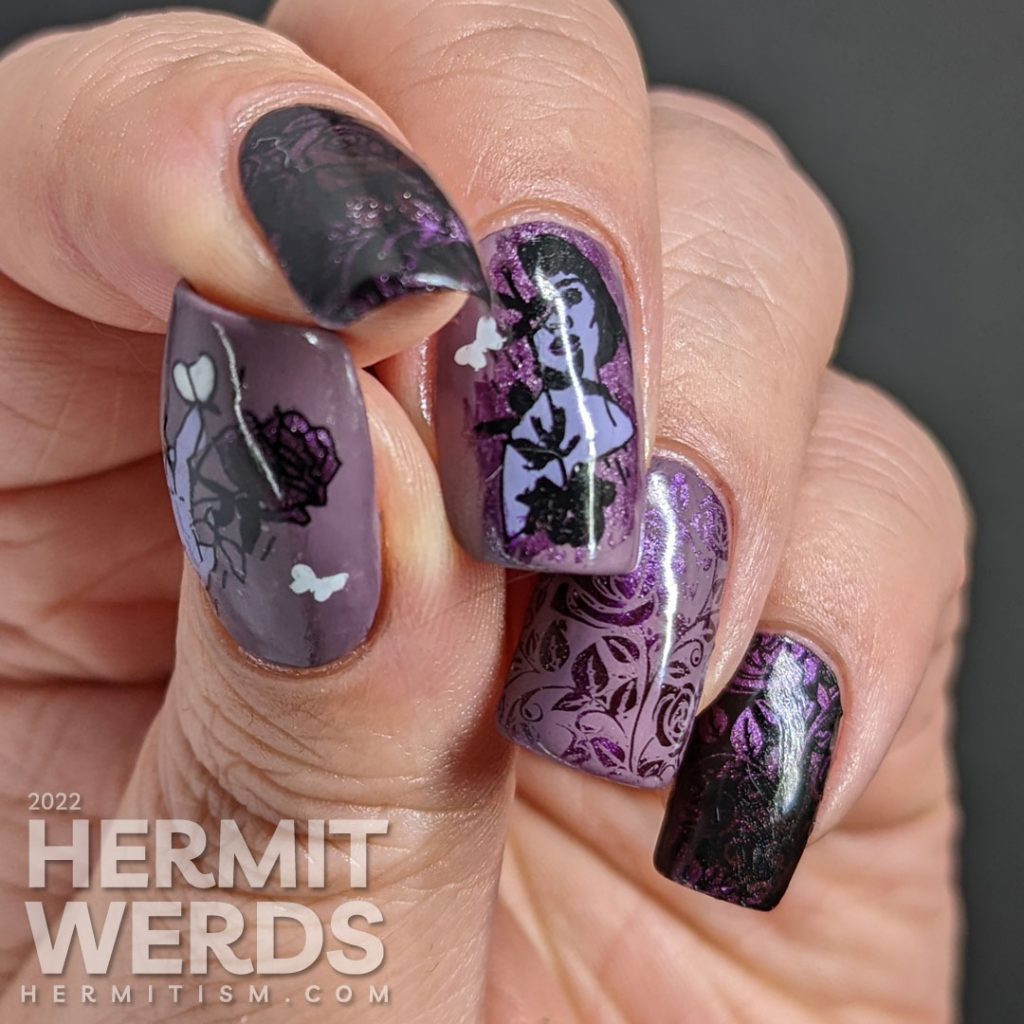 Dramatic purple rose nail art with a magnetic purple polish peeking out from negative space rose patterns and token butterflies.
