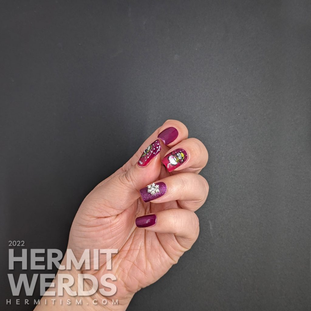 Beautiful berry mani with a textured accent nail + silver snowflake nail charm offset by stamping decals of scary bloody snowmen.