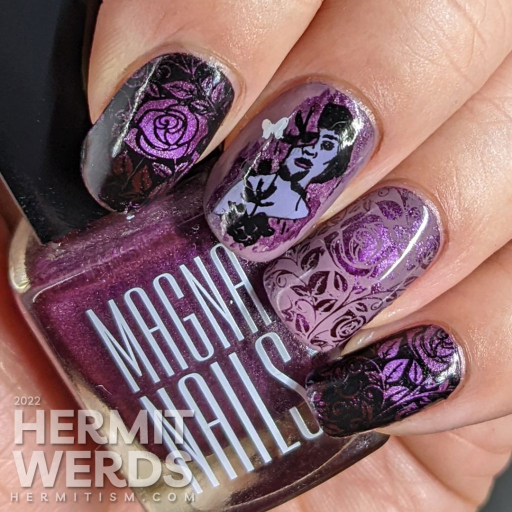 Dramatic purple rose nail art with a magnetic purple polish peeking out from negative space rose patterns and token butterflies.